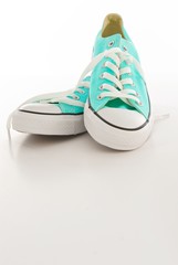 Turquoise and White Canvas Sneakers on a Blank Background