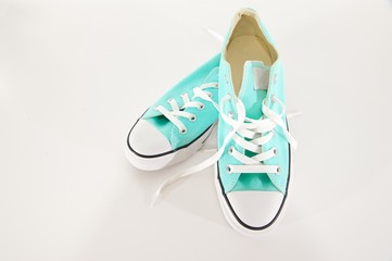 Turquoise and White Canvas Sneakers on a White Background