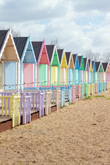 traditional British beach huts on a bright sunny day