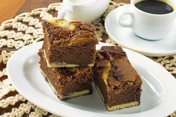 Cream cheese brownies on a white plate