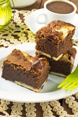 Cream cheese brownies on a white plate