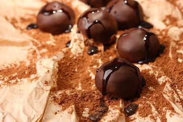 Chocolate candies with cocoa powder, close up