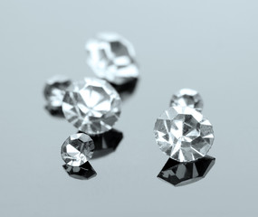 Beautiful shining crystals (diamonds), on grey background