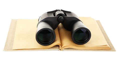 Black modern binoculars with old notebook isolated on white