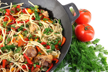 Noodles with vegetables on wok close-up