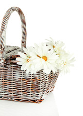 Fototapeta na wymiar Picnic basket with flowers, isolated on white