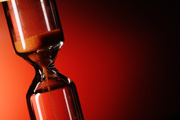 hourglass on red background © Chepko Danil