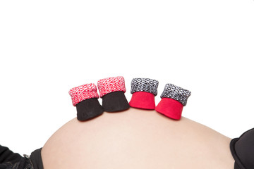 Pregnant belly with baby booties - 51954276