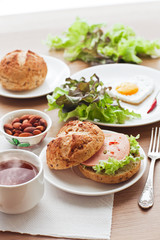 breakfast with hamburger, tea, egg and green salad