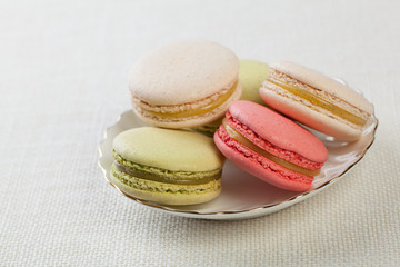 Delicious macaroons on vintage background