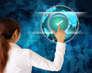 Business women pushing a button on a touch screen interface