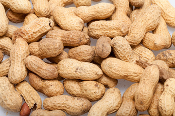 .Dried peanuts in closeup on the white background