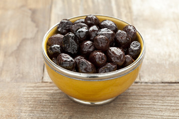 Yellow bowl with black olives