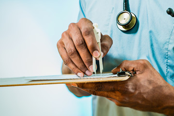 Doctor Using Calipers To Measure EKG