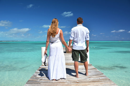 A couple on the wooden jetty. Exuma, Bahamas
