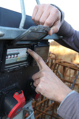 man turning on the fuse box