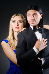 Pair in love in dark studio