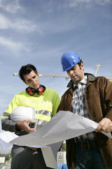 Construction workers looking at a blueprint