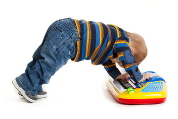 little boy and the keyboard on white background. funny boy baby.