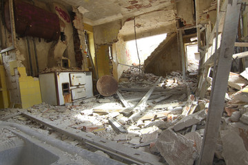 house destroyed by an explosion full of debris