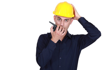 Confused architect holding radio