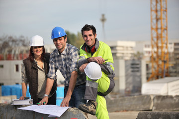 A team of construction workers - obrazy, fototapety, plakaty