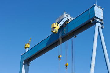 Gantry crane at shipyard on the background of blue sky
