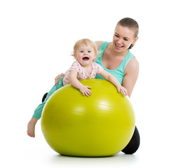 Fototapeta na wymiar mother doing gymnastics with baby on fitness ball