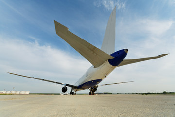 Rear view at airplane standing on parking from low angle