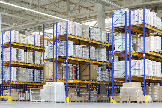Large warehouse with lots of tall shelves with packed containers