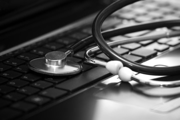 Stethoscope lying down on an laptop