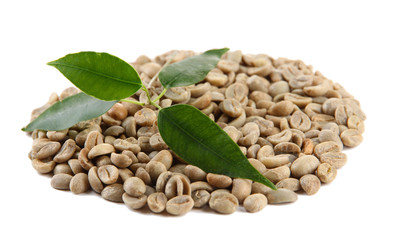 Green coffee beans and leaves isolated on white