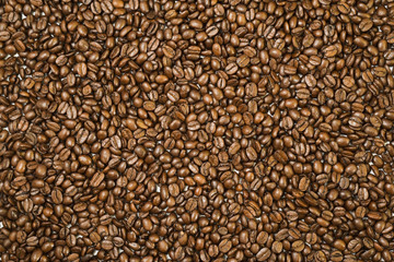 Surface covered with coffee beans as a background