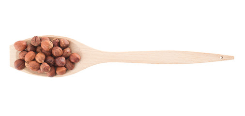 Spoon full of hazelnuts isolated