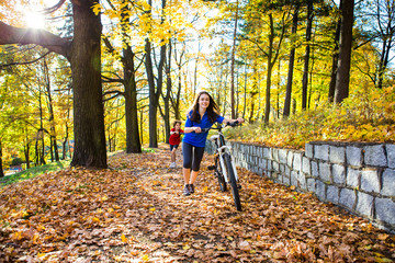 Fototapeta premium Urban biking - teens riding bikes in city park