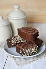 Chocolate cake and two pots on wooden background