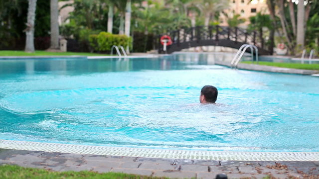 Man jumping into swimming pool