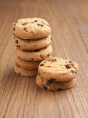 stack of chocolate biscuits with chocolate on wooden table