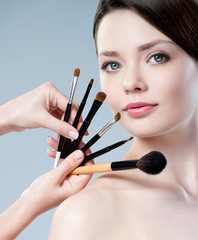 beautiful woman. Makeup brushes.