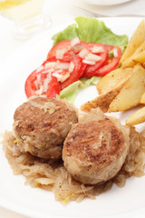 Meatballs with stewed onion and fried potato wedges