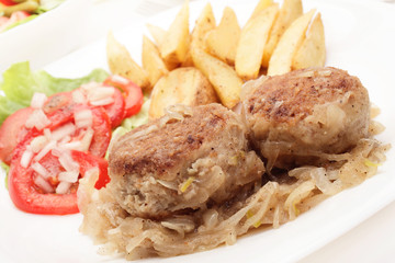 Meatballs with stewed onion and fried potato wedges