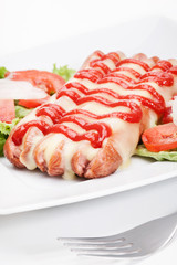 Closeup of baked sausage witch cheese. Selective focus