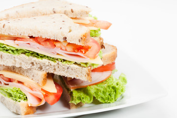Ham and cheese sandwiches on plate