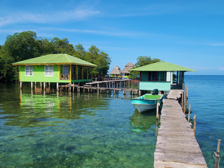 Tropical resort over the water with wooden dock and bungalows, Caribbean sea, Bocas del Toro, Panama