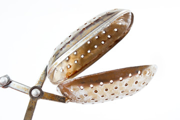 Vintage tea strainer , opened , isolated on white