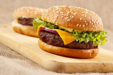 Homemade grilled hamburgers on wooden board - 52000864
