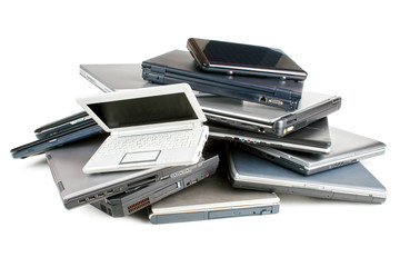 Stack of different sized and aged laptops, isolated