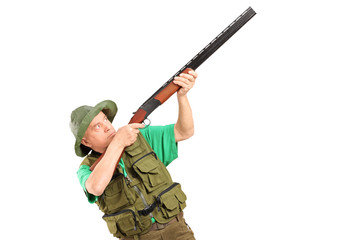 Fototapeta premium A male hunter shooting with a shotgun
