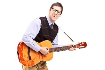 A young male playing a guitar