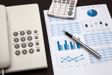 business report with telephone on a table